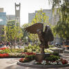 An image of the owl statue and students on Main Campus